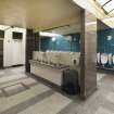 View of urinals and central hand basins in Gents toilets.