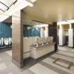 View of urinals and central hand basins in Gents toilets.