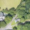 Oblique aerial view of Cairness House South Lodge and St Columba's Episcopal Church, looking W.