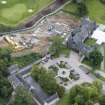 Oblique aerial view of Meldrum House, stables and dovecot, looking ENE.