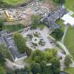 Oblique aerial view of Meldrum House, stables and dovecot, looking NE.