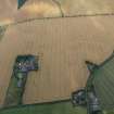 Oblique aerial view of the cropmarks of the round house and the pit defined boundaries, looking W.