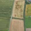 Oblique aerial view of the cropmarks of the enclosure and the rig, looking W.