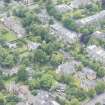 Oblique aerial view of East Morningside House and St Bennets Archiepiscopal Chapel, looking NW.