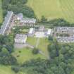 Oblique aerial view of Duddingston House, Offices and Stables, looking WSW.