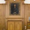 First Floor, General view of fireplace and portrait above in lecture room.