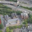 Oblique aerial view of St Mungo's Roman Catholic Church and Martyrs' Public School, looking E.