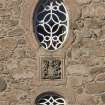 Detail of windows and coat of arms above main entrance.