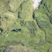 Oblique aerial view of buildings and enclosures on Pabbay, looking SE.