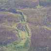 Oblique aerial view of Raasay mine workings and railway, looking NE.