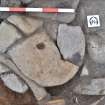 Rotary quernstone (SF1.02) in situ Trench 1 hearth, Comar Wood Dun, Cannich, Strathglass