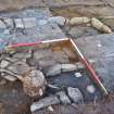 South west corner of hearth section - showing hearth edge and base slabs and rotary quernstone, Comar Wood Dun, Cannich, Strathglass