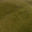Oblique aerial view of the hut circles and field system at Gleann Crom, looking east.