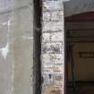 Detail of exposed cavity wall where ventilation bricks have been lost revealing concrete wall and interior brick wall.