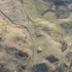 Oblique aerial view of the farmstead at Bad an Loin and the Grave of Diarmid four poster stone circle in Glen Shee, looking ESE.