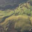 Oblique aerial view of a farmstead, field system and rig at Knock Barrie, looking S.