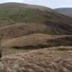 A view looking NE of the Roman watch tower at the pass of Ewes Doors, with Ewenshope Fell in the background. A tripod marks the centre of the site.