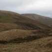 A view looking E of the Roman watch tower at the pass of Ewes Doors, with Ewenshope Felland Whin Fell in the background.