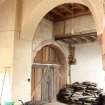 View of north west wall of gatehouse from gardener's store, showing 3-part door, timber ceiling, loft space and linking archway, photograph from a historic building appraisal at Muirfield Gate, Duncur Road, Gullane