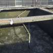 Water filtration plant. View of tank no. 4 from south, Filtration process beginning. Central pipe forces air into the gravel and this air is bubbled up through the water to agitate it.The tank contains filters consisting of 4 layers of gravel through which the water passes to remove all solid foreign bodies