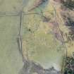 Oblique aerial view of the farmstead and standing stone at Clach More, looking SSW.