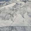 Oblique aerial view of the building, clearance cairns and military road at Corrymuckloch, looking S.