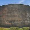 Former brick clad fuel tank, view from south west. Removed brick cladding (anti blast measure) can be seen in the patina of the metal tank wall