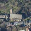 Oblique aerial view of St Michael's Parish Church and Beadle's House, looking NW.