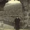 View of Neidpath Castle entrance gateway, with lady carrying photographer's bag