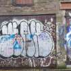 Panoramic view of graffiti on garages.