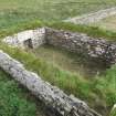 Outbuildings, N room abutting the principal range, and overlying the footings of another