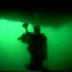 Photograph of diver under stern of HMS Breda