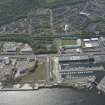 Oblique aerial view of Cappielow Park, Cappielow Jetty, James Watt Dock and Sugar Warehouse, looking SW.