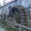 View of 'start and awe' breastshot paddle type waterwheel made of wood and cast iron, from south east