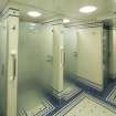 Basement. Mens locker room shower cubicles.