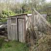 View from north east. The over shot water wheel is of metal construction and is encased within a wooden jacket. This waterwheel powered an electricity generator in the adjacent building.