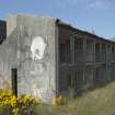 View of graffiti art by Derm, Timid and Stormie Mills on gable end of accommodation block, taken from the east.