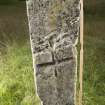 View of upright slab with incised cross in middle of stone (including scale)