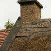 Detail of chimney, thatched ridge and tiled roof; Quoins Cottage, Longforgan Main Street.