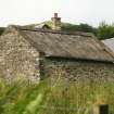 Rear view of bothy to show thatched roof and concrete ridge; Nether Tullicro, Dull.