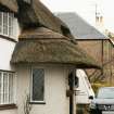Side view to show thatching over doorway; Rose Cottage, Town Yetholm.
