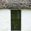 View of thatching with stone weights above window; Totscore, Skye.