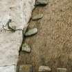 Detail of stone weights on thatch beside chimney breast; thatched cottage Reumisgarry, North Uist.