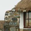 Detail of roof corner and weights above window; probable 19th century cottage; Laimrig Ruadh, Berneray.