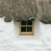 Detail of thatch and stone weights above window;  probable 18th century thatched cottage; Struan Ruadh, Malaclete.