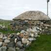 Rear view of thatched outbuilding with stone weights;  Hilltop Cottage, North Uist.