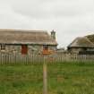 View of renovated thatched single storey cottage and outbuilding; Rhugha Sinish, South Uist.
