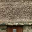 Detail of thatched roof, ridge and weights above doorway;  Rhugha Sinish, South Uist.