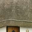 Detail of netted thatch with rope over doorway;  51 Balgarva, Eochar, South Uist.