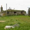 View of ruinous c.1900 former thatched cottage, with roof mostly collapsed; South Smercleit, South Uist.
